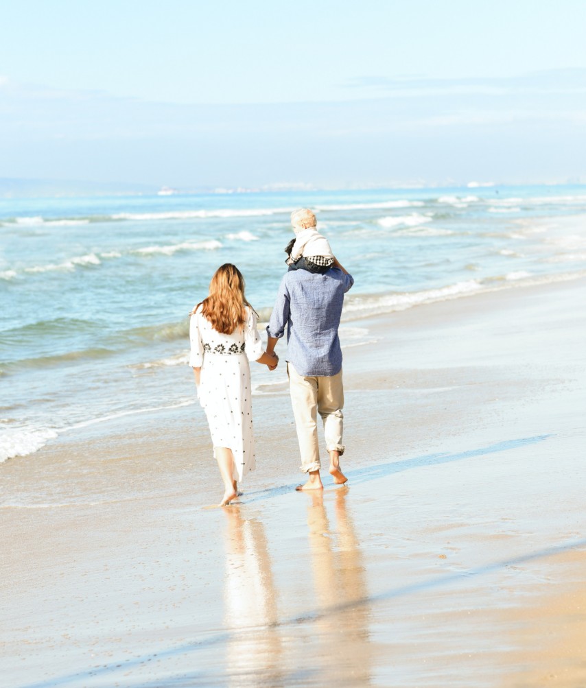 Family Walking on Beach | Suzanne Polino REALTOR